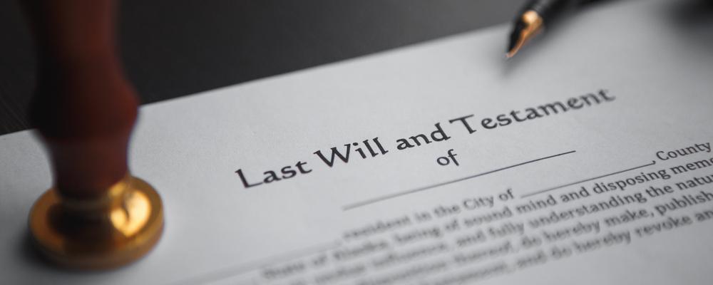 Last will and testament papers over will contest attorney's desk